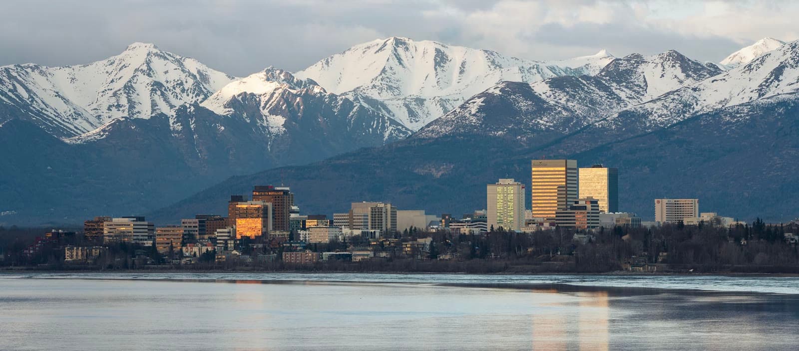 Downtown Anchorage across Cook Inlet with the Chugach Mountains: Rockstarr Media is casting new faces in Anchorage