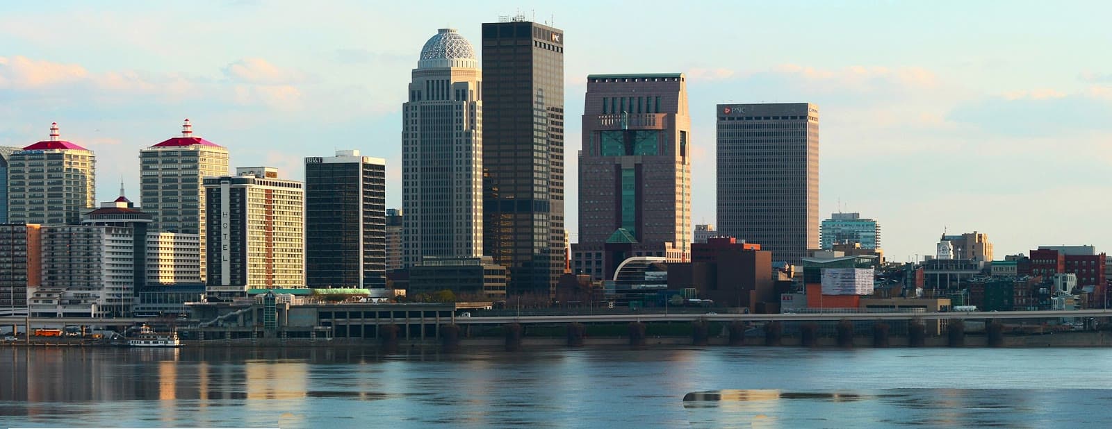 Downtown Louisville across the Ohio River in soft late-day light: Rockstarr Media is casting new faces in Louisville