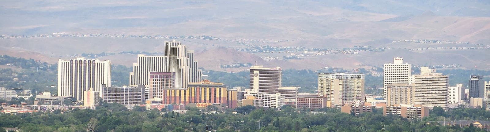 Downtown Reno against the hills in warm evening light: Rockstarr Media is casting new faces in Reno