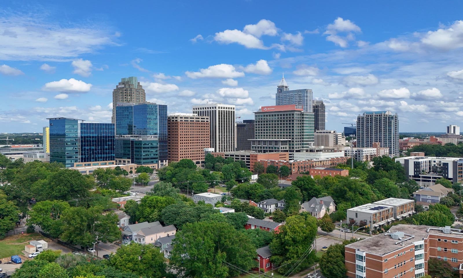 The downtown Raleigh skyline above a sea of green trees: Rockstarr Media is casting new faces in Raleigh