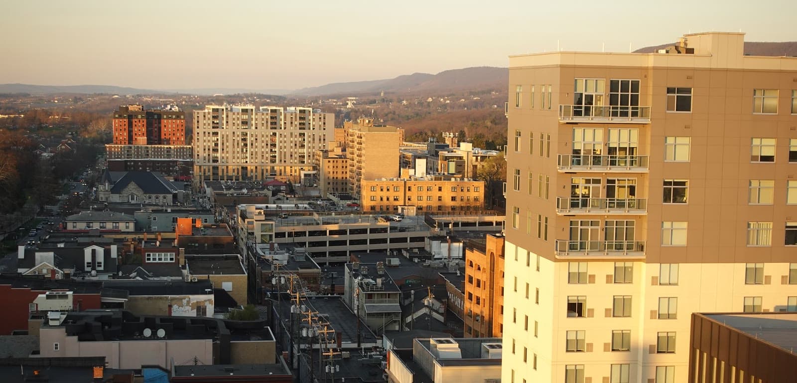 Downtown State College at golden hour with the Nittany Valley ridges: Rockstarr Media is casting new faces in State College