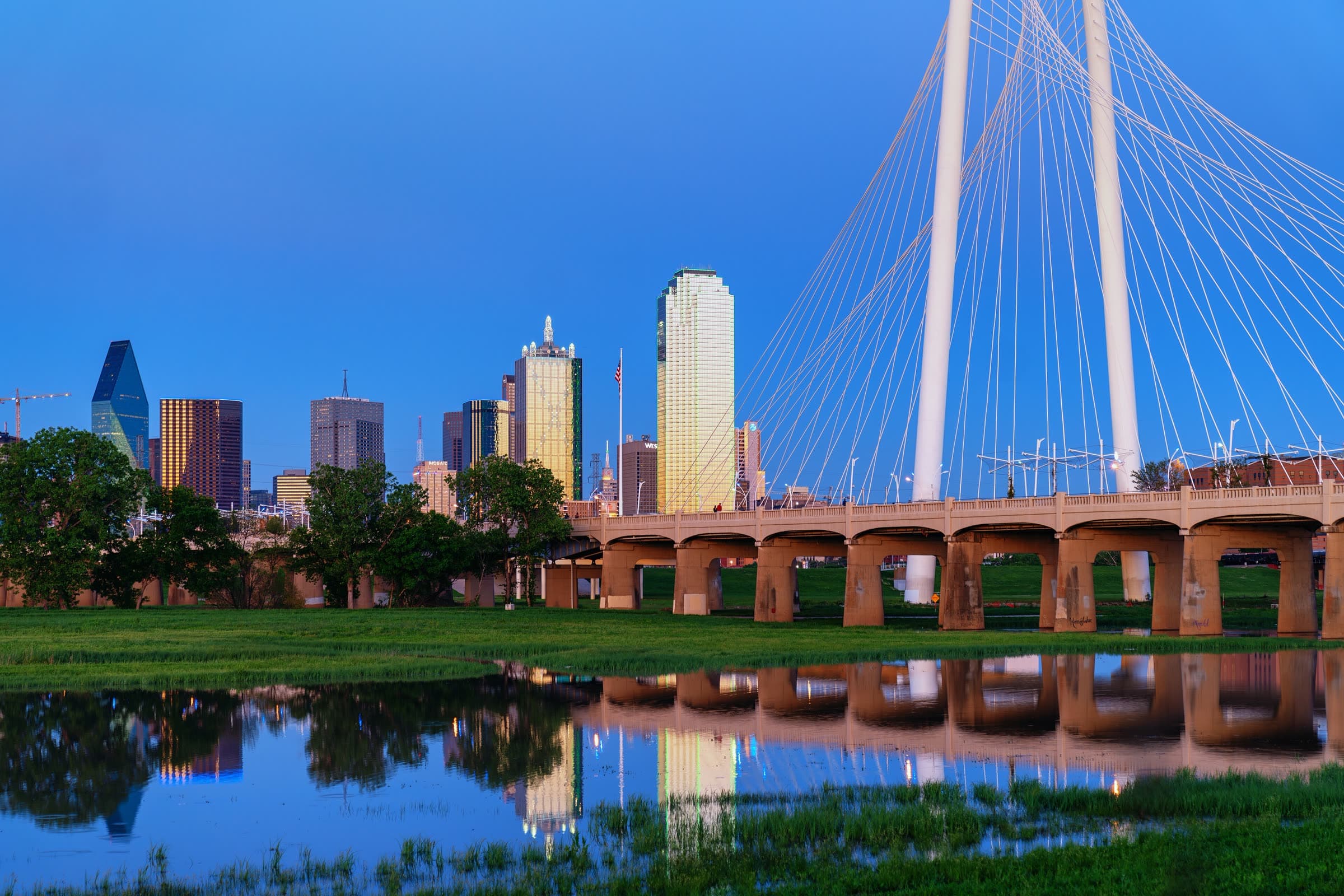 The Dallas skyline and the Margaret Hunt Hill Bridge over the Trinity River in Dallas, Texas